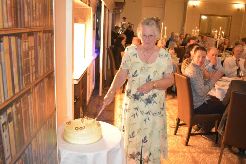 Celebrating 50years Gwenda Roberst cutting the cake