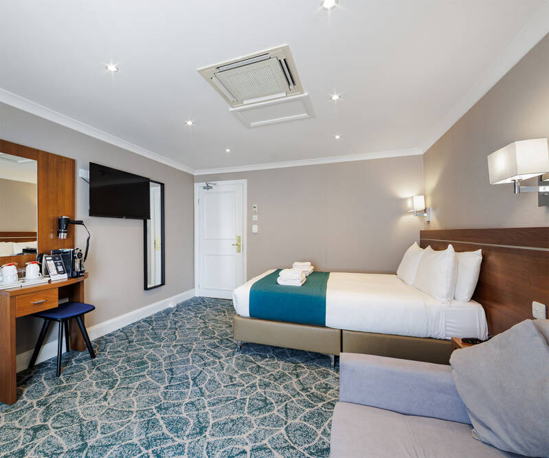 Elegant renovated double room with modern furnishings in a Victorian London hotel
