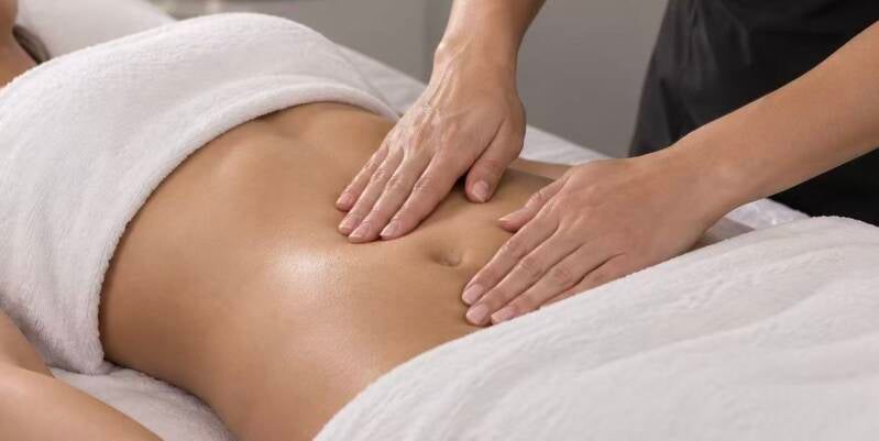 Mommy Makeover lymphatic drainage massage in St. Cloud, FL with gentle hands-on abdominal techniques to support post-op swelling, fluid movement, comfort, and multi-area recovery.