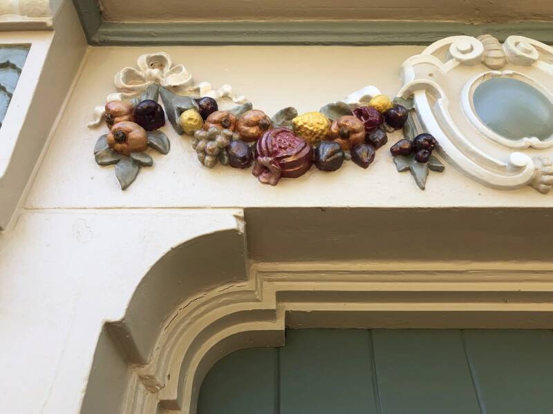 image of a stone embellishment draping over a front door, carefully painted and colored to bring out the details