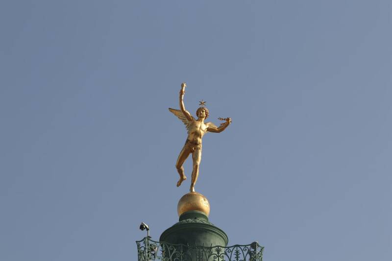 alt'Golden statue of the Spirit of Liberty (Genie de la Liberte) atop the July Column, Place de la Bastille, Paris.