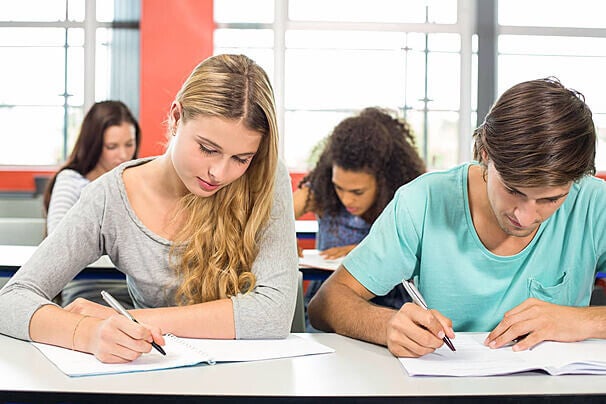 Adult students taking a DELF French exam after French online tutoring.