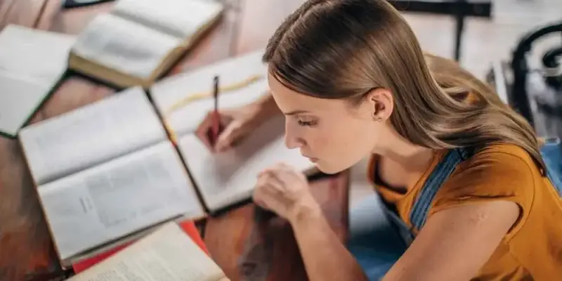 French A-Level Student writing an essay in an exam.