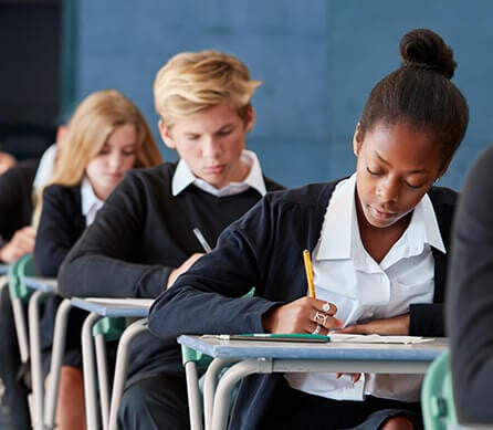 School children sitting their 11+ grammar school entrance tests under timed exam conditions.