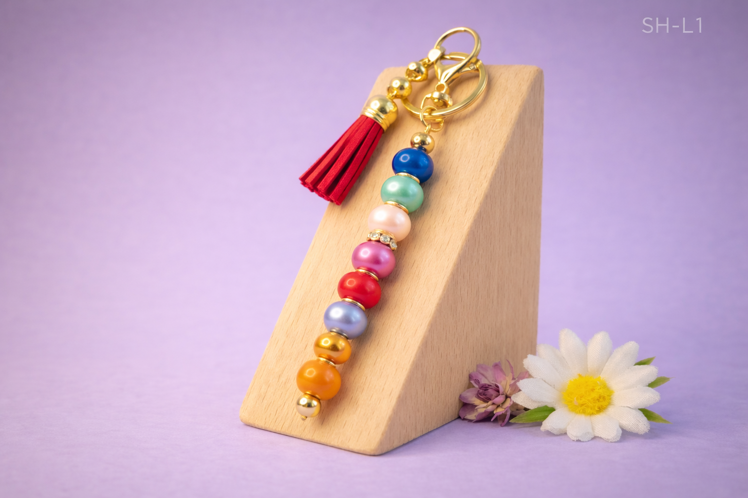 💜 Sleutelhanger – kleurrijke kralen met rode kwast