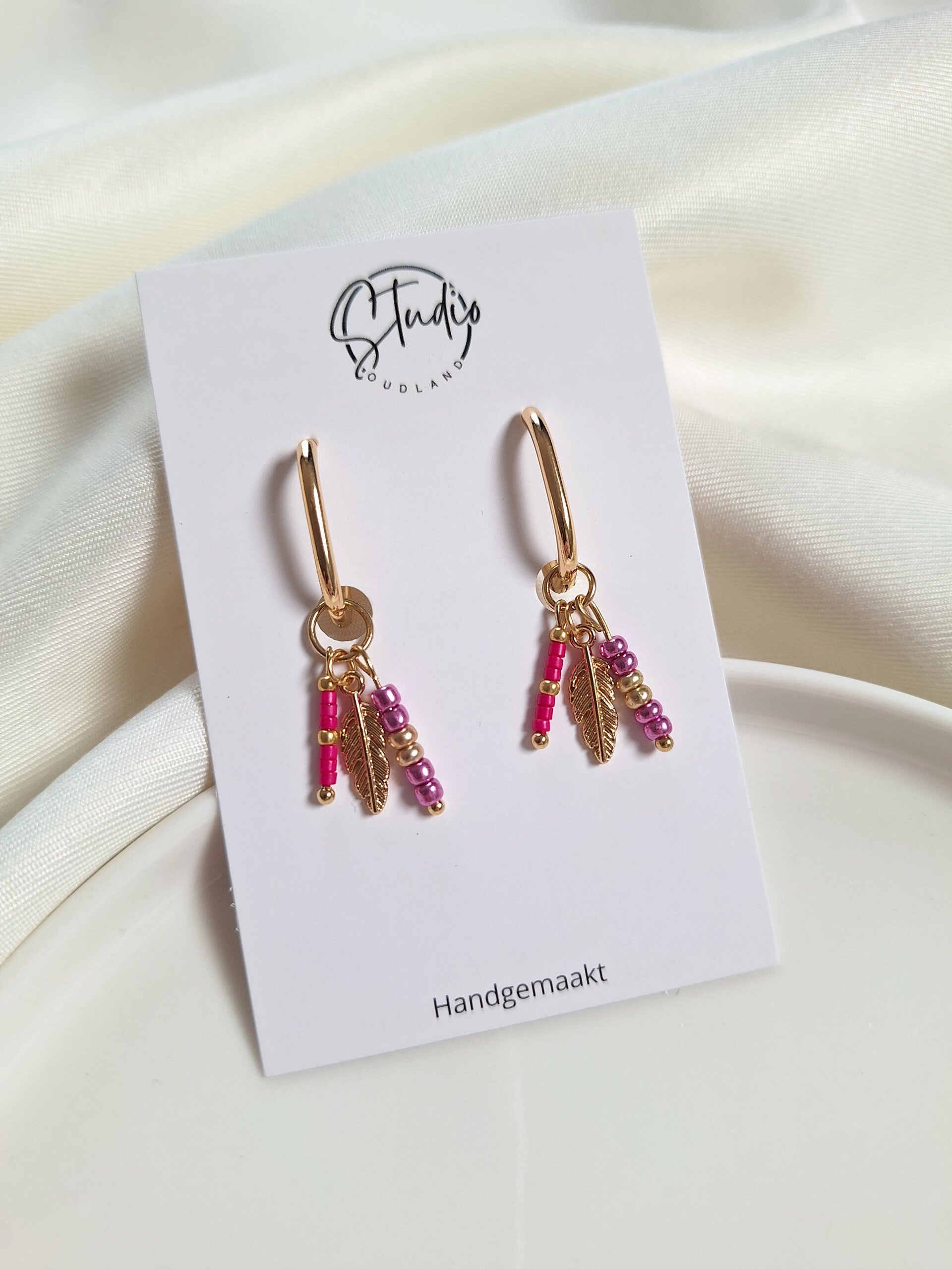 RVS oorbellen met bedels roze