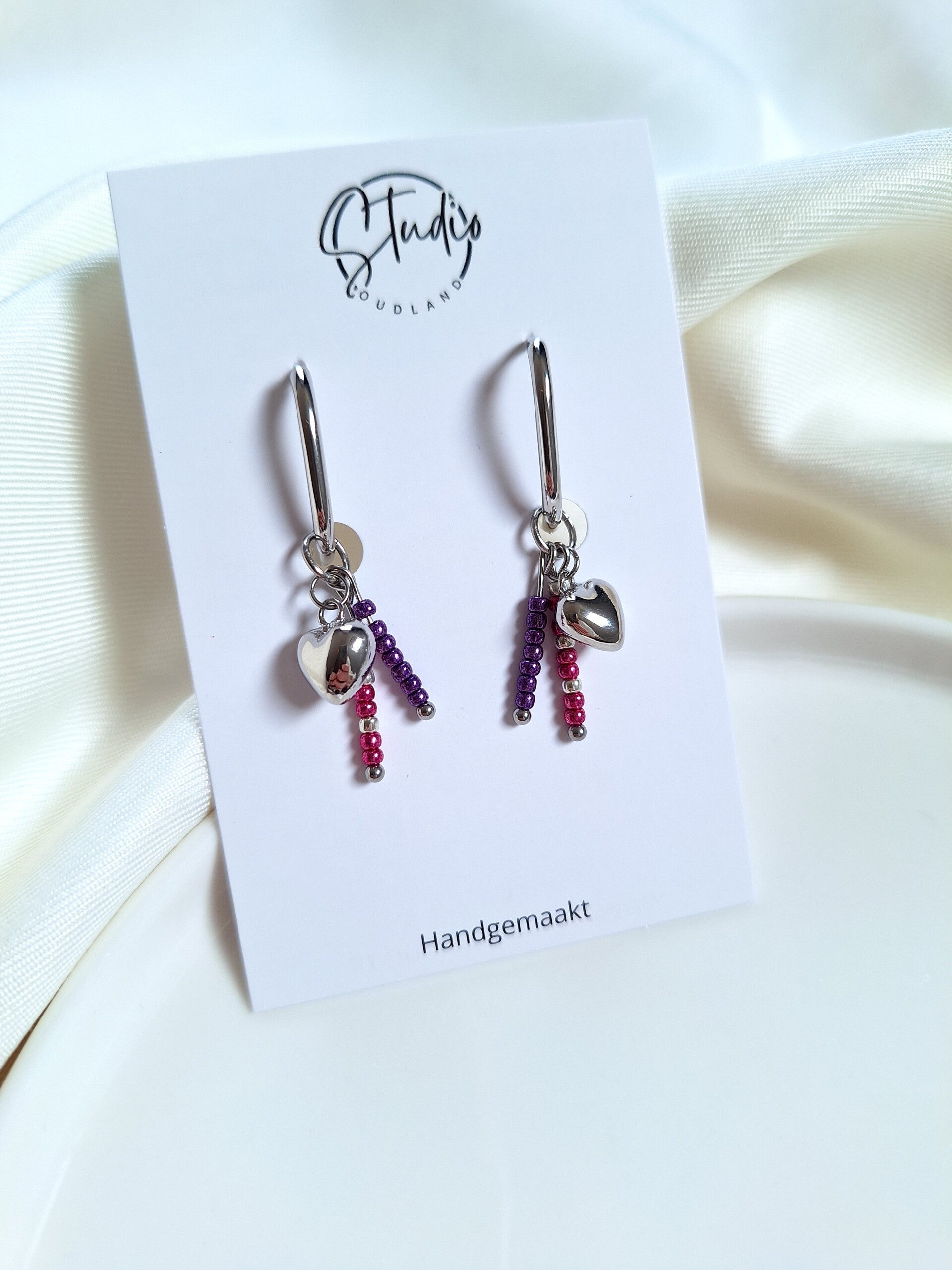 RVS oorbellen met bedels paars/roze