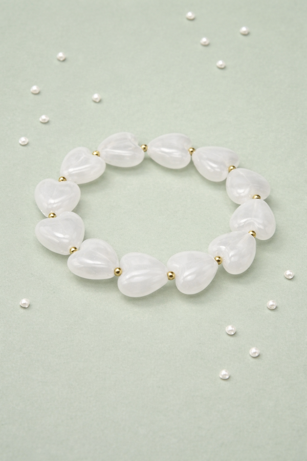 Bracciale elastico con cuori bianchi in resina e acciaio inossidabile
