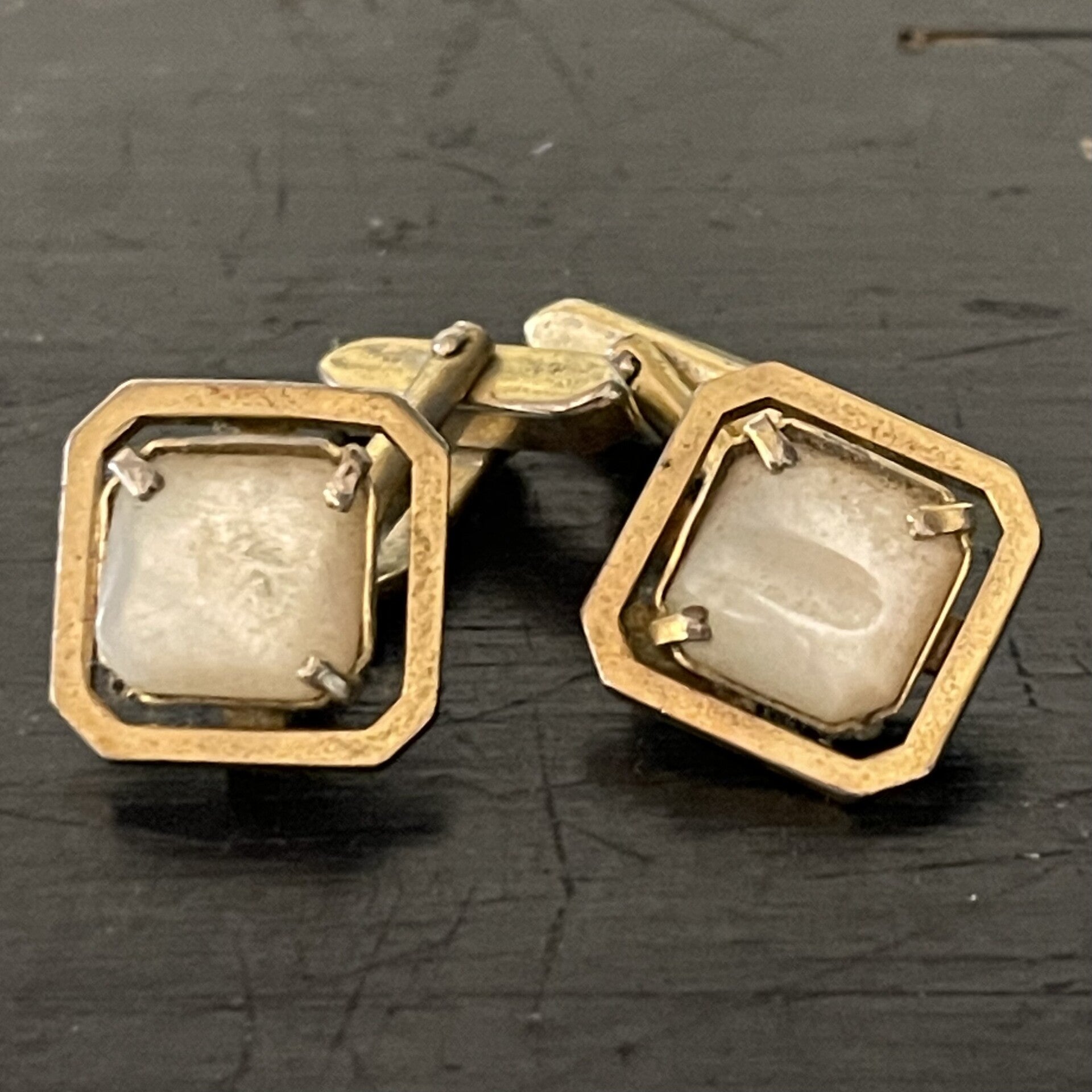 Manchetknopen goudkleurig met wit parelmoer.