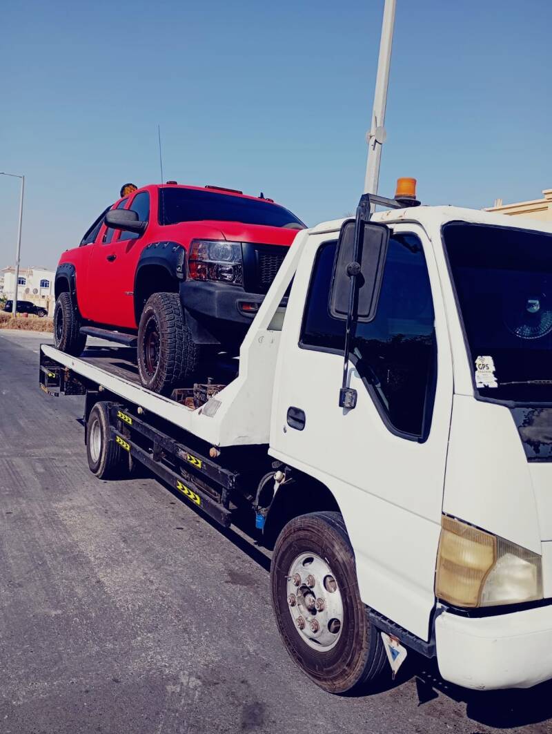 Heavy-duty winch tow truck rescuing a SUV stuck off-road near Saadiyat Island beach area Abu Dhabi