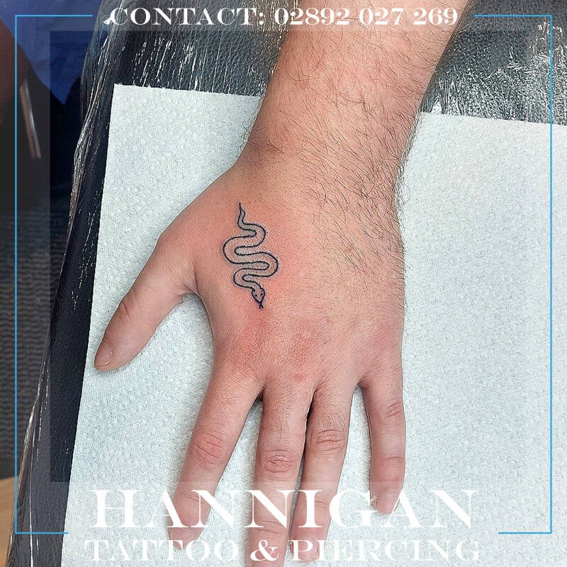 snake hand tattoo