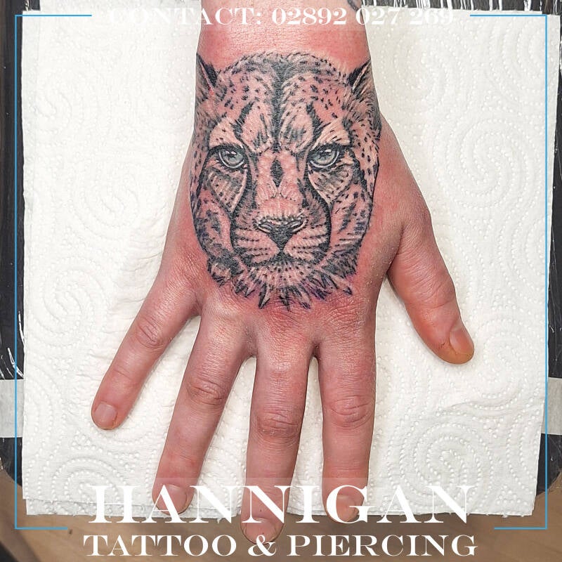 white cheetah hand tattoo