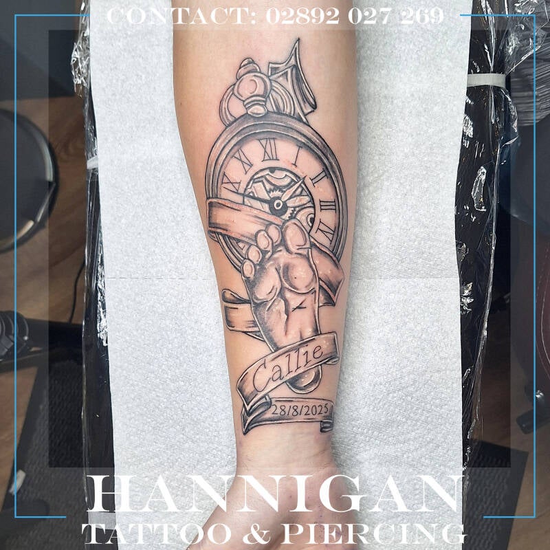clock and baby arm tattoo