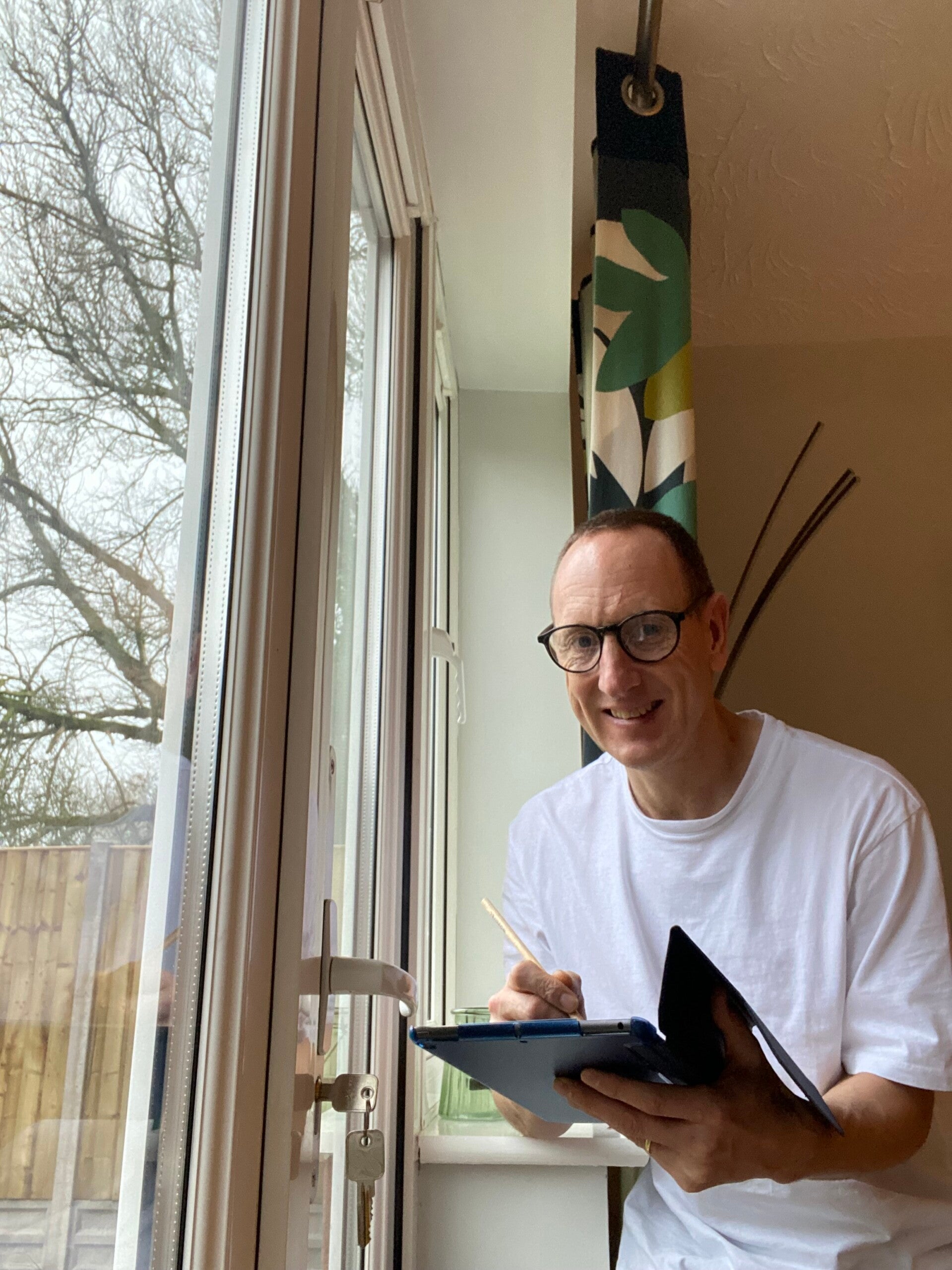 A photo of Dr Jonny Acheson drawing on his IPad