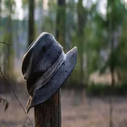 old-hat-hangs-barrel-fence-under-sunlight-shined-behind-hat-traces-fractions-background-you-can-183143732-standard.webp
