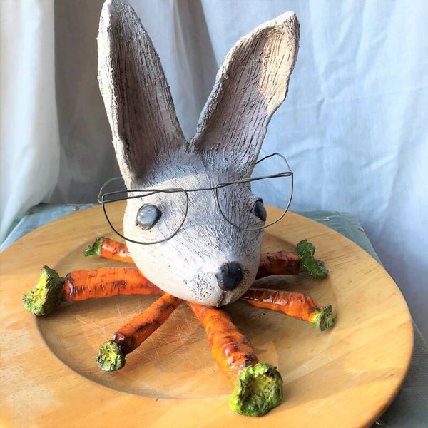 Bunny on a bed of carrots.