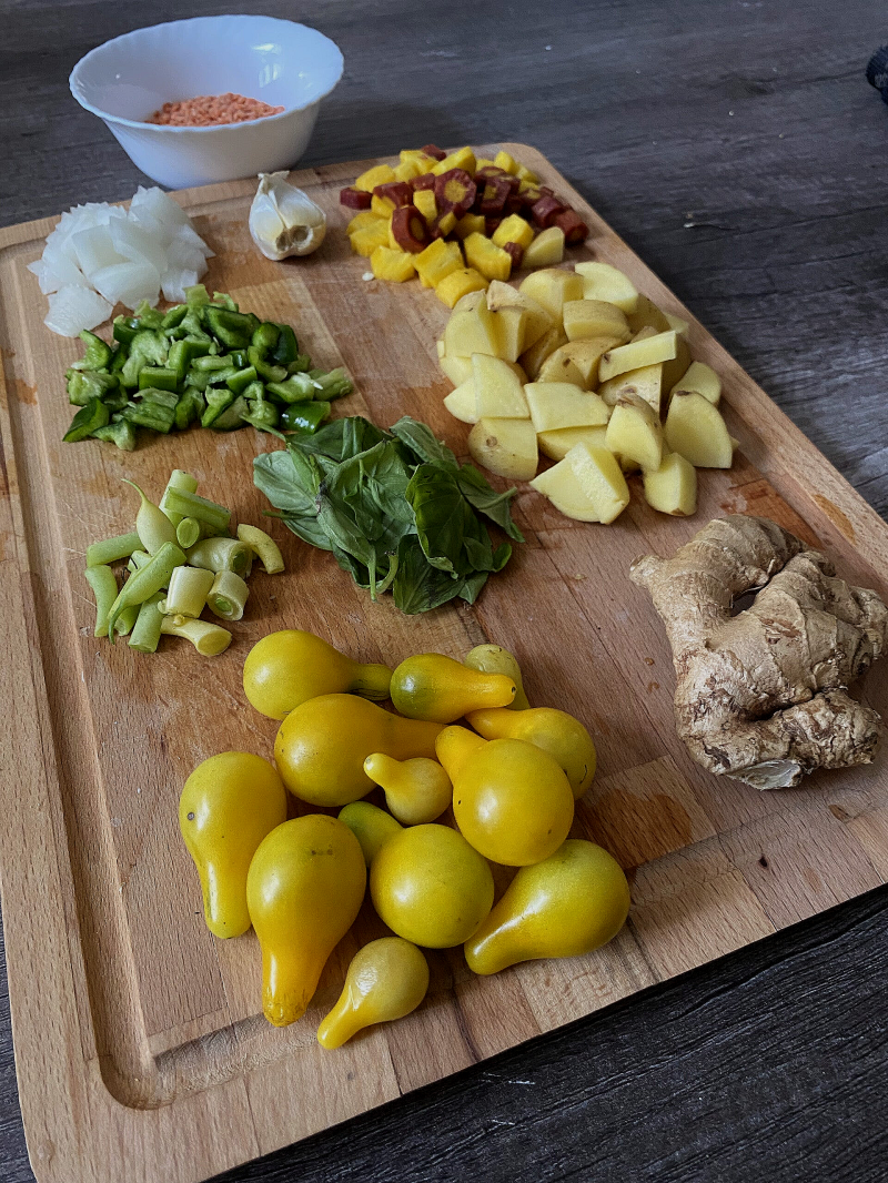 ingredients grown in the garden, potatoes, tomatoes, ginger, onions, peppers, carrots, and beans