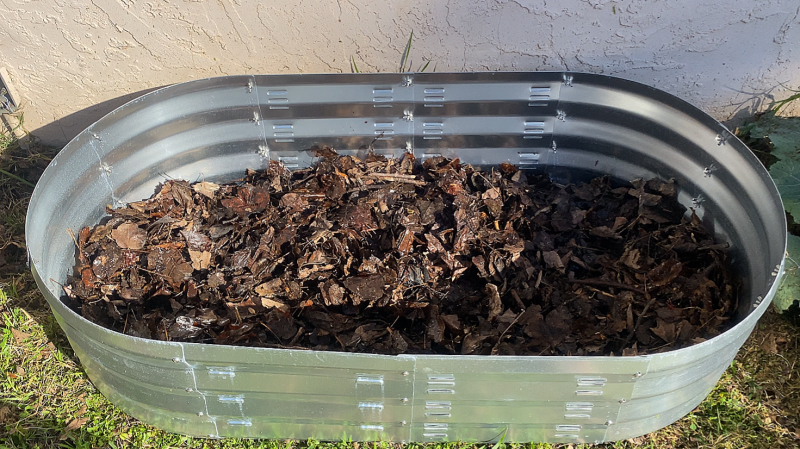 filling raised bed with leaves