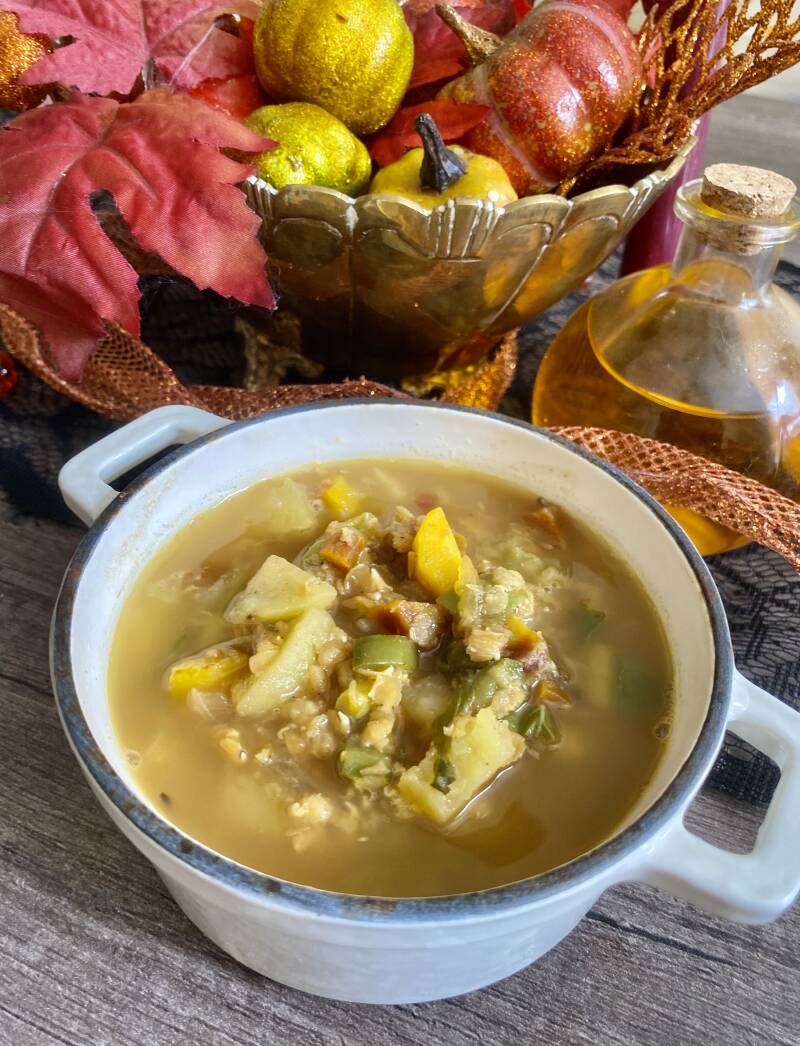 Finished red lentil soup with carrots, potatoes, peppers, beans, basil, tomatoes, and more