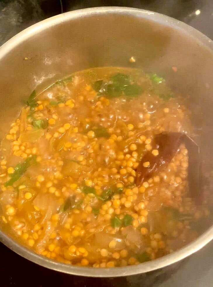 red lentils boiling with pasilla pepper and basil