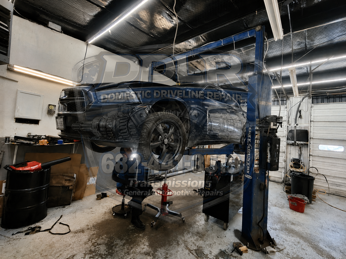 "Technician removing a transmission from a vehicle during transmission rebuild service in Arlington TX"