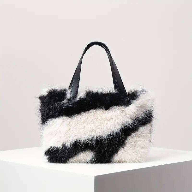 nepbonte schoudertas in wit met zwart dessin en 2 korte handvaten