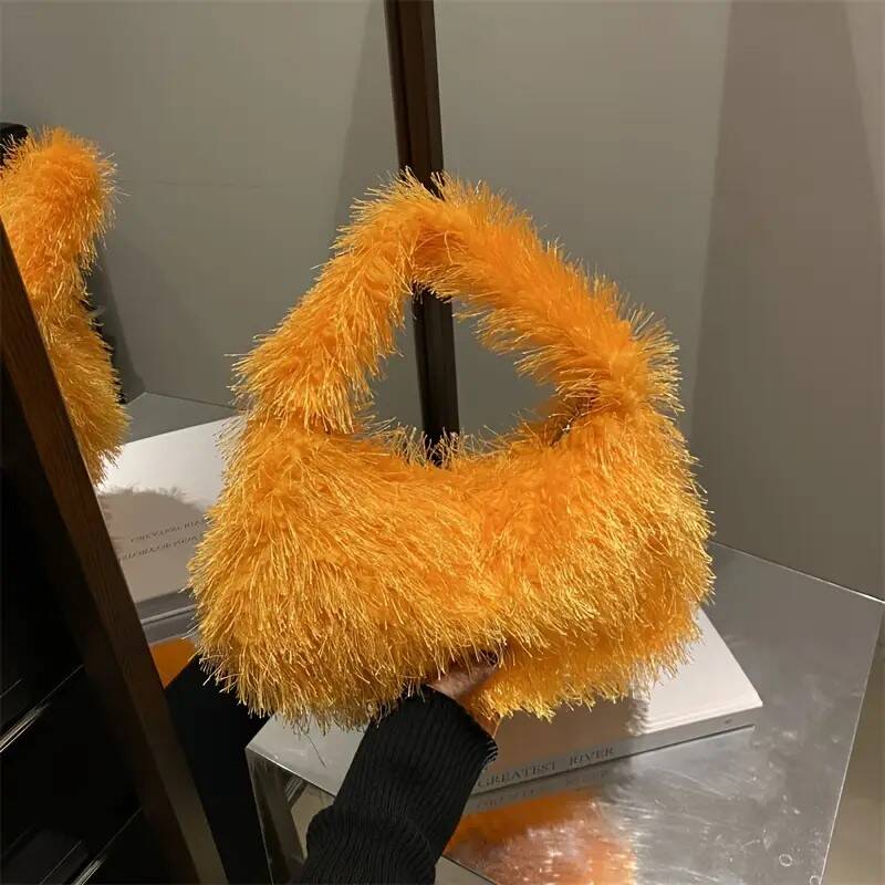 Aparte trendy nepbonte tas in geeloranje kleur.