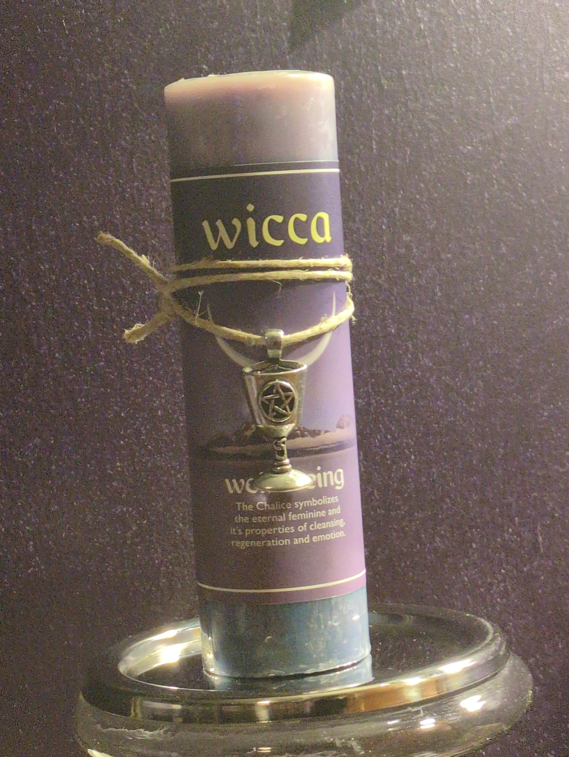Wicca "Well Being" pillar candle featuring a pewter chalice pendant, often used in ritual work.
