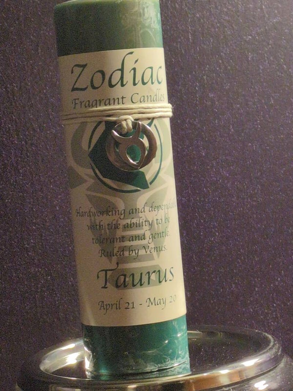 Taurus-themed zodiac pendant candle is decorated with a pewter charm representing the bull symbol.