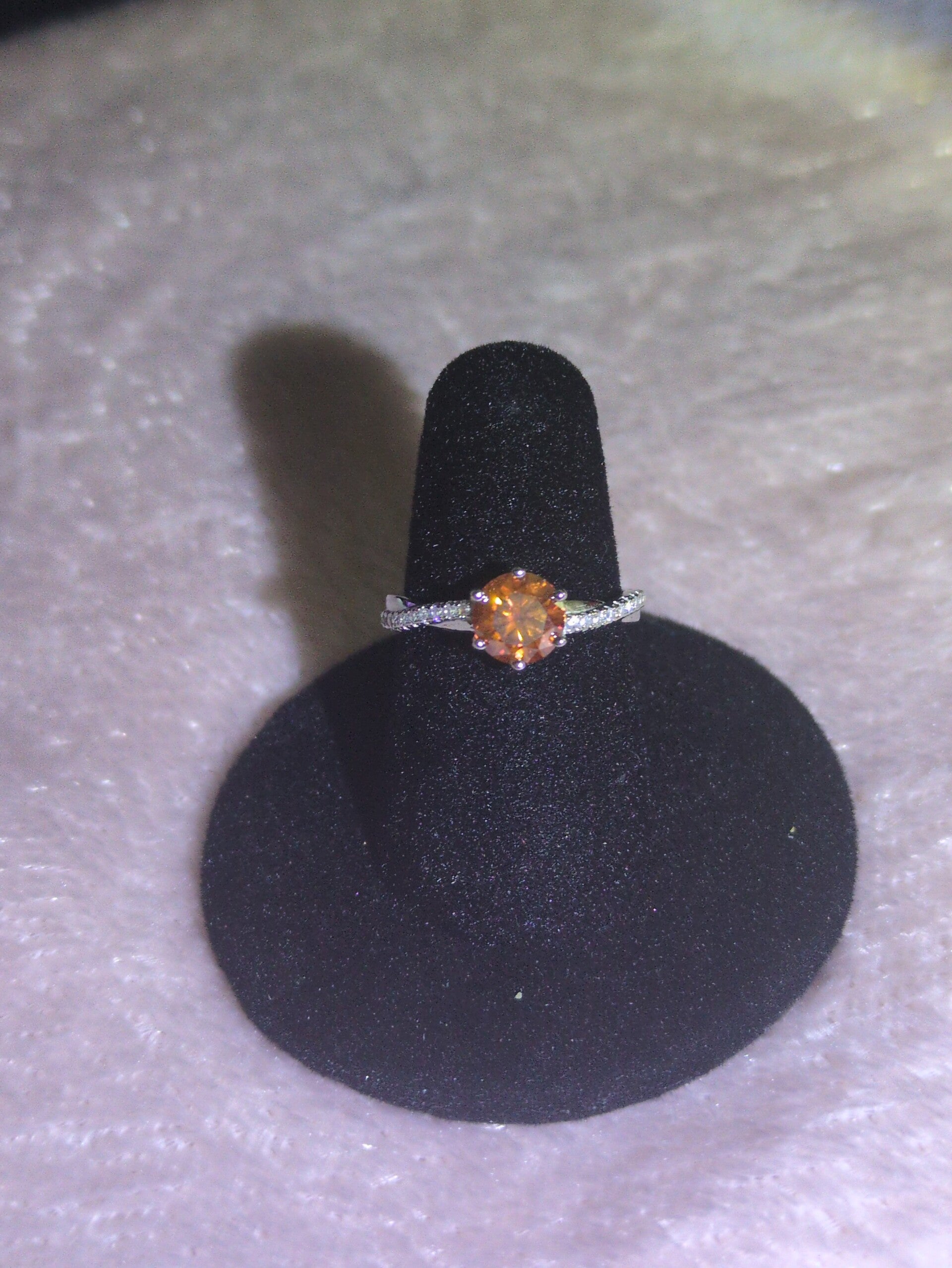 This size 7 ring features a brilliant-cut, fiery orange gemstone moissanite —set in a classic six-prong solitaire mounting.