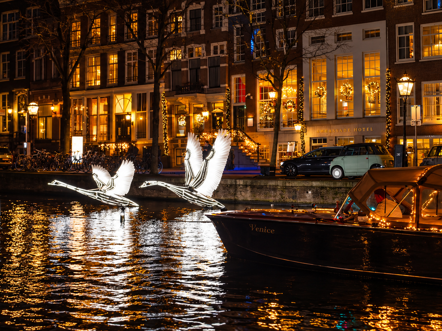 Venice passing the illuminated swans of the Amsterdam Light Festival