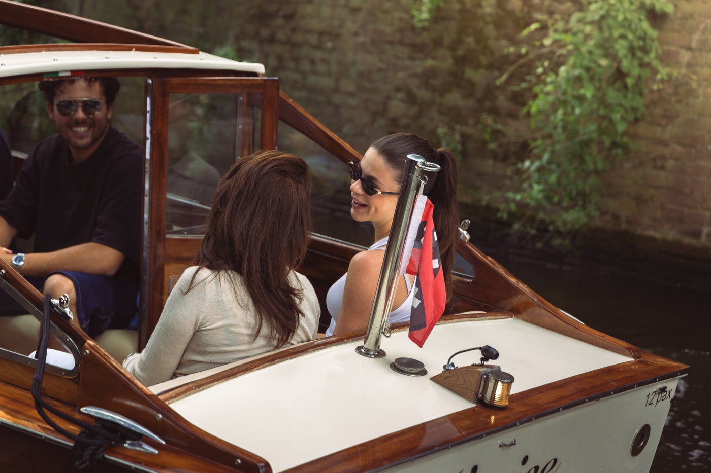 Guests with champagne in the heated cabin of Venice on a winter evening in Amsterdam