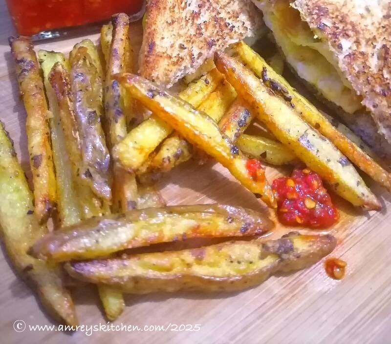 Herbed Fries on a wooden board with Amrey's Kitchen Sambal Oelek. Recipe and photo by Amrey Boquiren of Amrey’s Kitchen™.