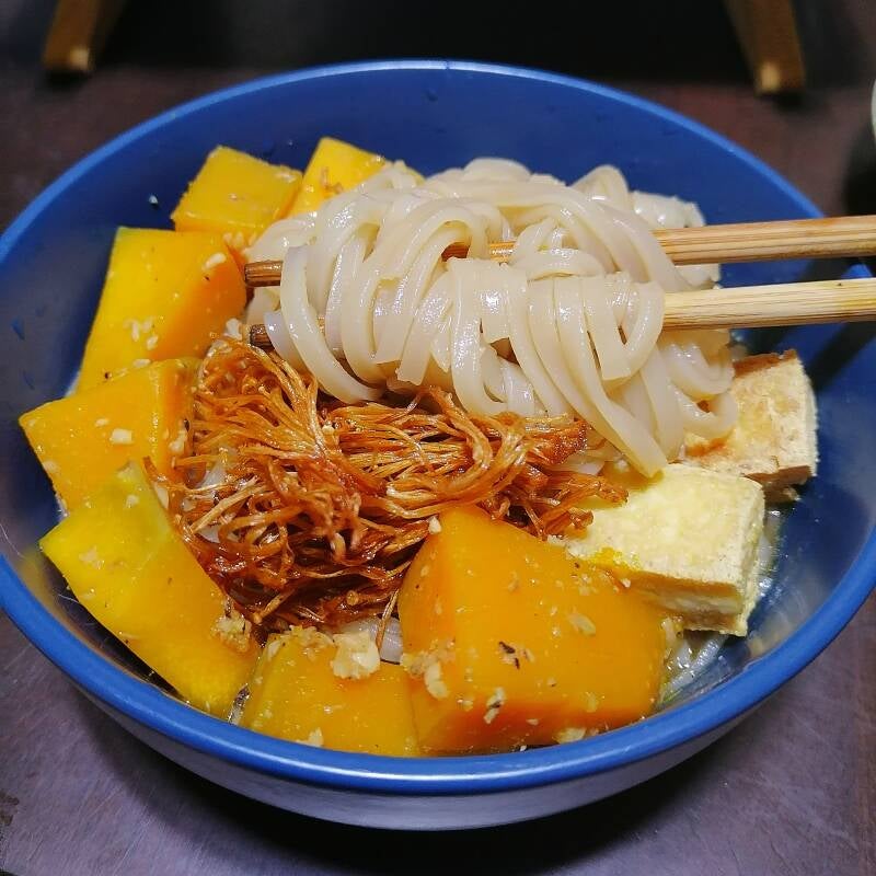 Vegan Soy-Ginger Rice Noodle Soup with Kabocha Stir-Fry and Fried Tofu and Enoki Mushrooms in a blue ceramic bowl.  Recipe and photo by Amrey Boquiren for Amrey’s Kitchen™.