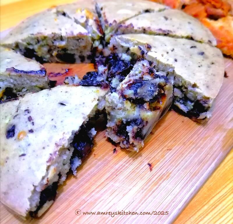 Air-Fried Vegan Dark Chocolate and Raisins Pancake on a wooden board, sliced. Recipe and photo by Amrey Boquiren for Amrey’s Kitchen™.