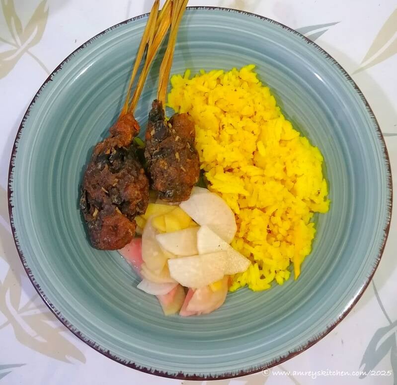 vegan lemongrass skewers with ginger-turmeric rice and pickled radish, onion, ginger (ROG) on a blue ceramic round dish. Recipe and photo by Amrey Boquiren of Amrey’s Kitchen™.