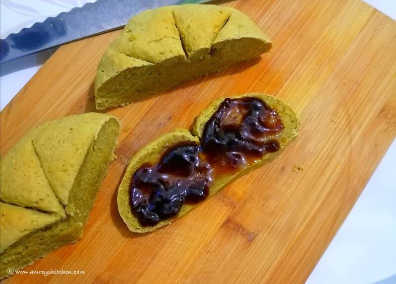 Sliced No-Yeast Vegan Moringa Bread with jam on a wooden board. Recipe and photo by Amrey Boquiren of Amrey’s Kitchen™.