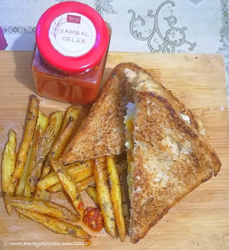 Amrey’s Kitchen™ Sambal Oelek, Herbed Fries and Egg Sandwich on a wooden board.  Recipe and photo by Amrey Boquiren of Amrey’s Kitchen™.