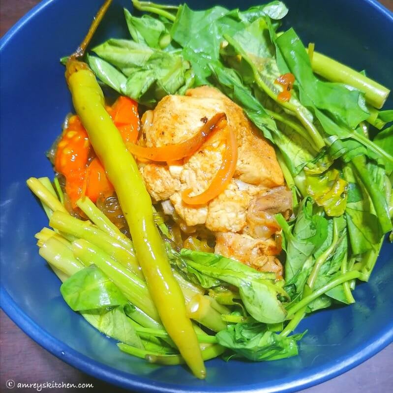 Spicy Pan-Fried Sour Chicken Noodle Soup in midnight blue ceramic bowl. Recipe and photo by Amrey Boquiren of Amrey’s Kitchen™.