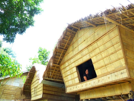 Woman sitting by the window of a T'boli hut in Lake Sebu, Philippines, 2015. Photo taken by Francesca Divinagracia for Amrey Boquiren of Amrey's Kitchen.