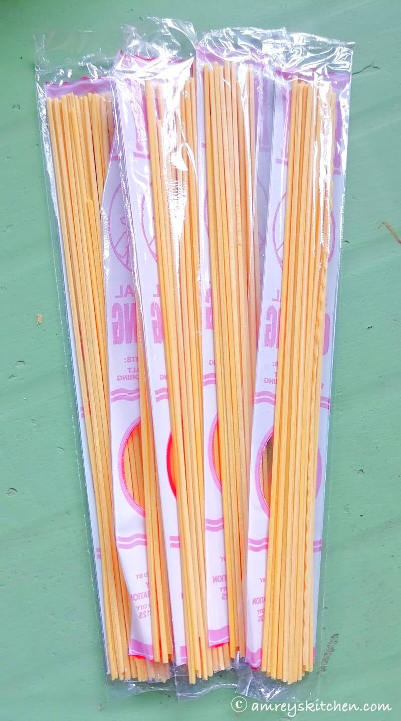 Udong noodles in packet on a green table. Photo by Amrey Boquiren of Amrey’s Kitchen™, Kina Amapola™, and Pawntee’s Grub™.