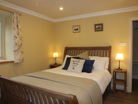 holiday home bedroom with french doors to terrace