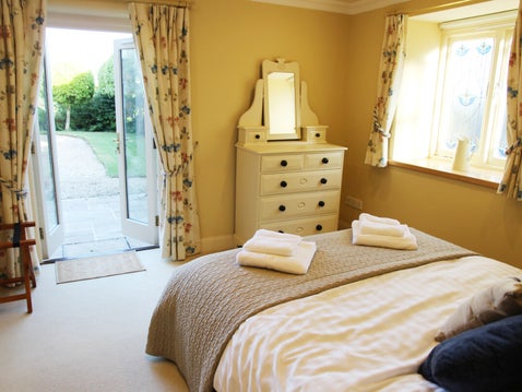 En suite bedroom with french doors in holiday home