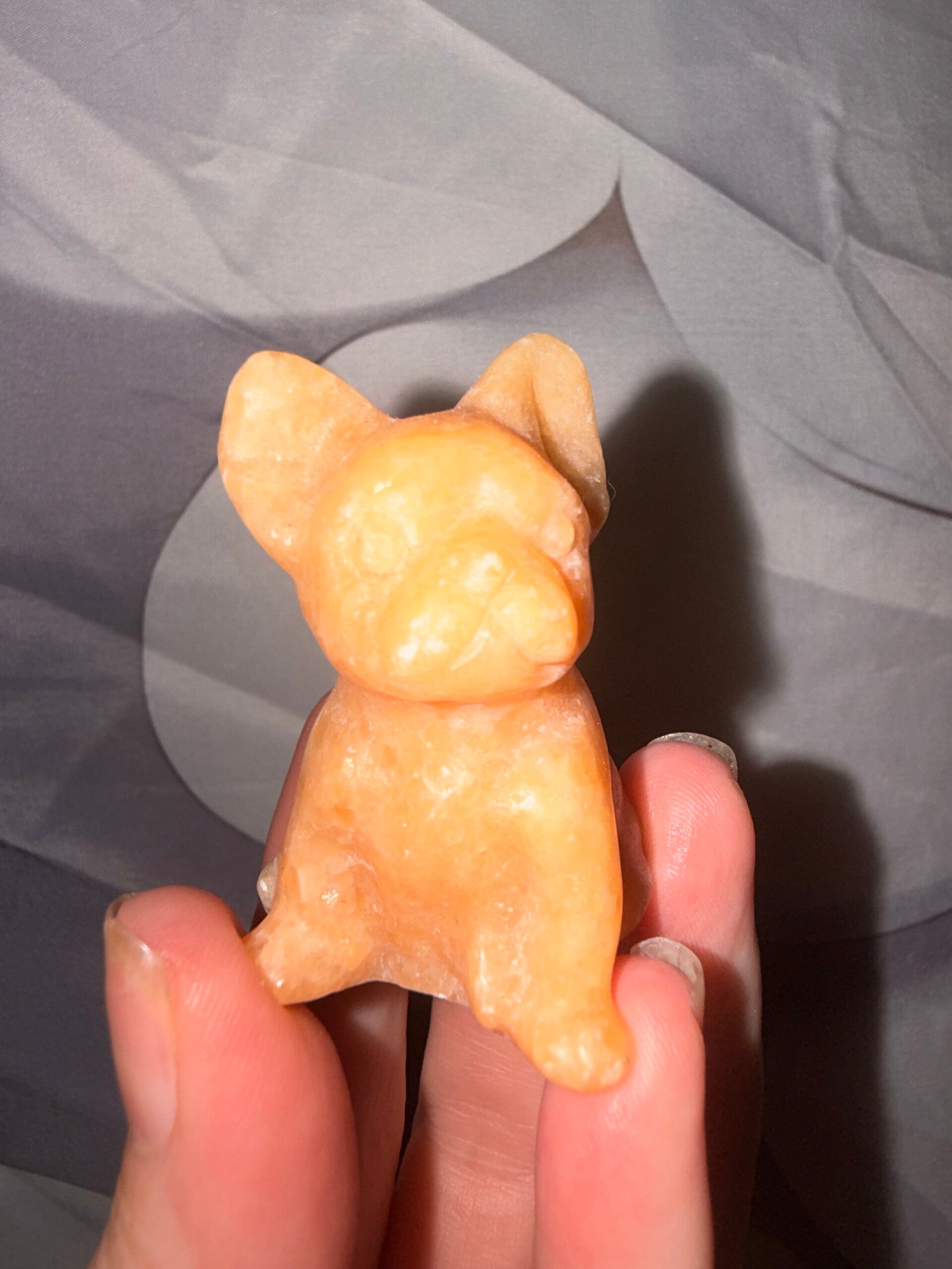 Orange calcite bulldog carving