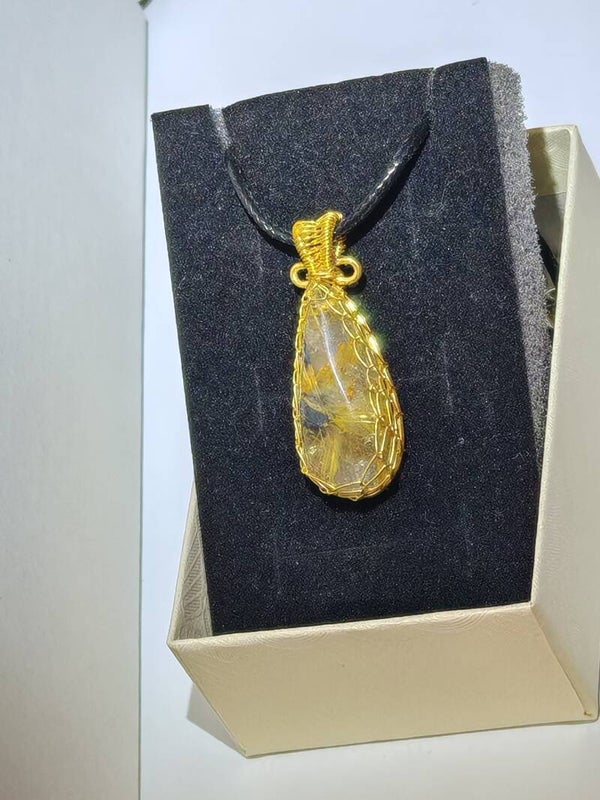 B2 Copper Rutile quartz necklace set in golden metal on a rope chain