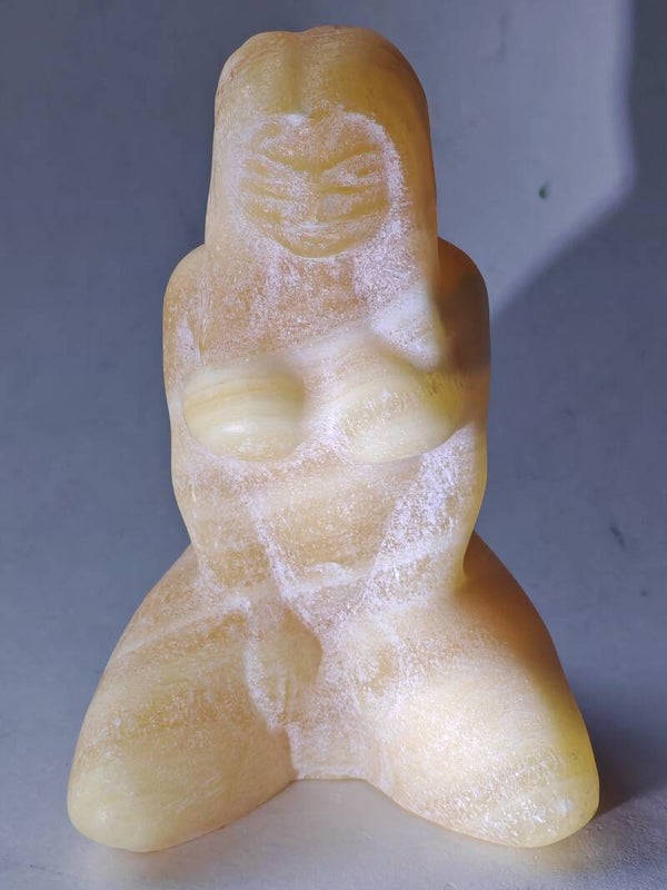 Orange Calcite kneeling woman