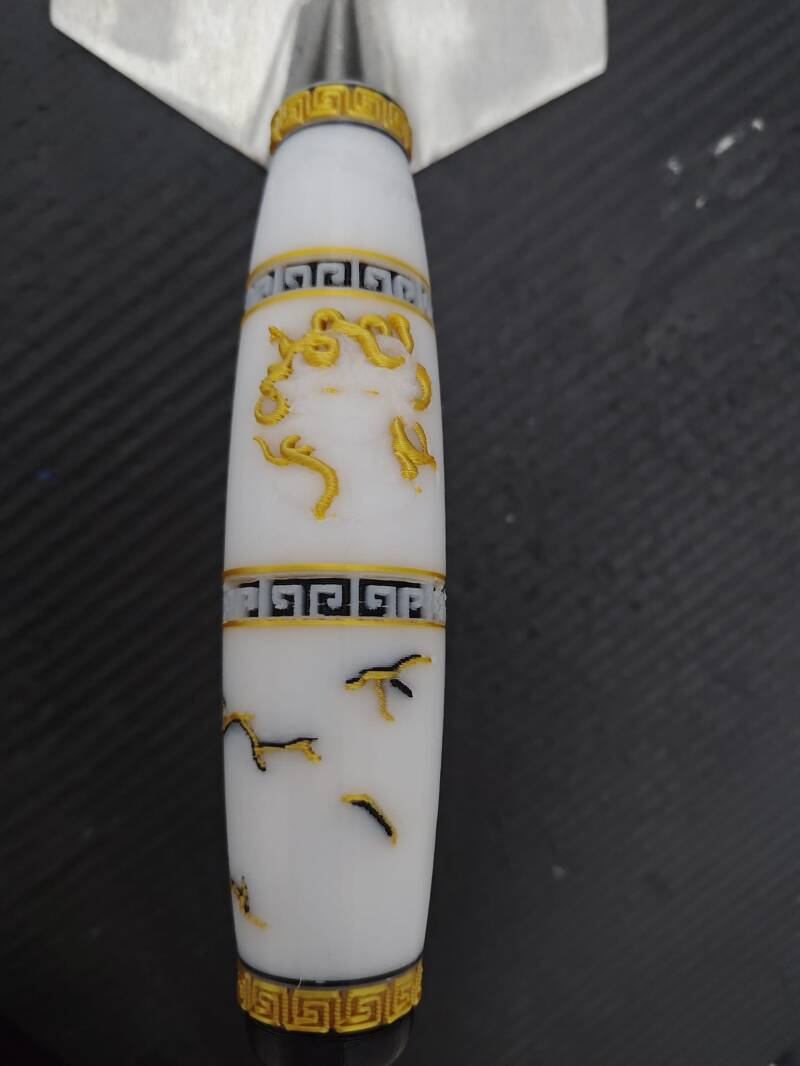 White handle with a gold decorative design