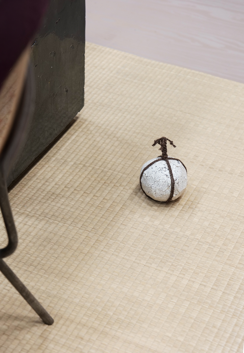 Cord-wrapped stone by Thomas Takada, photographed at Salone Raritas during Milan Design Week 2026.