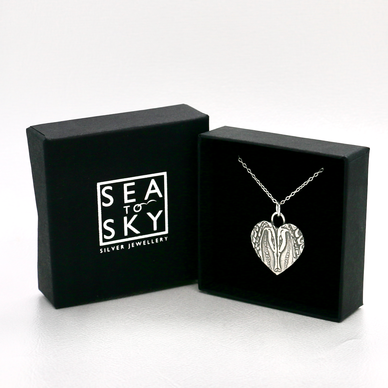 Necklace displayed in black and silver gift box with sea to sky silver logo