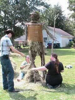 Some event participants and I filling his legs with straw.
